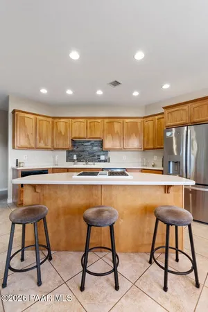 a kitchen with stainless steel appliances granite countertop a sink counter space cabinets and a large window