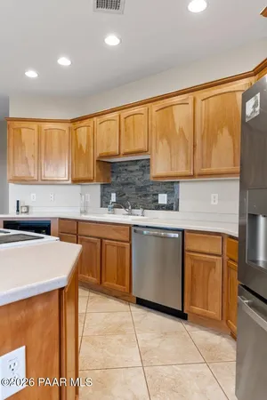 a kitchen with stainless steel appliances kitchen island granite countertop a sink and cabinets