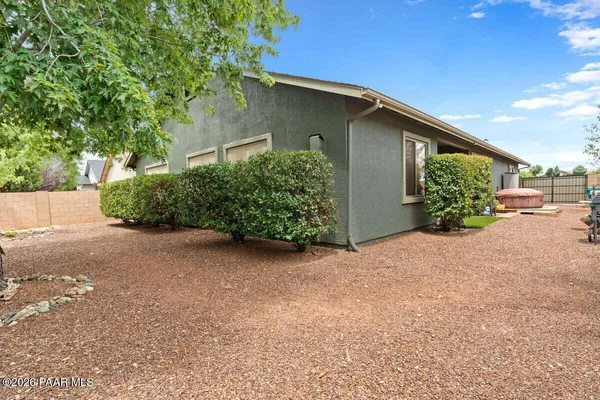a view of a house with a yard and sitting area