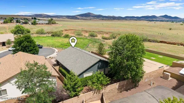 an aerial view of a house with a ocean view