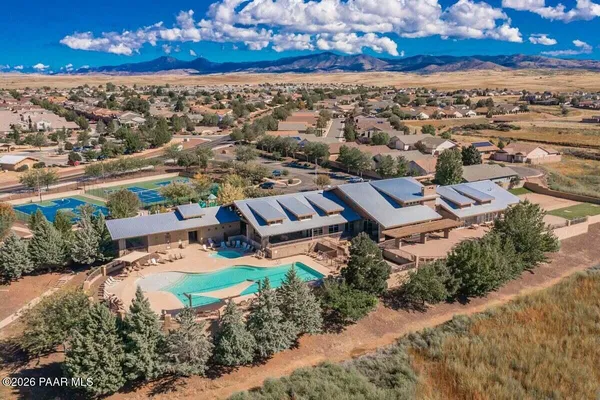 an aerial view of residential building and trees around