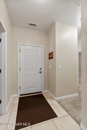 a bedroom with a bed and a potted plant