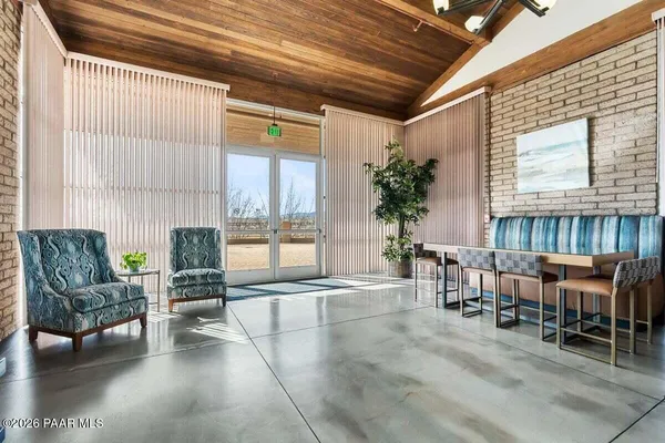 a room with pool table flat screen tv and windows