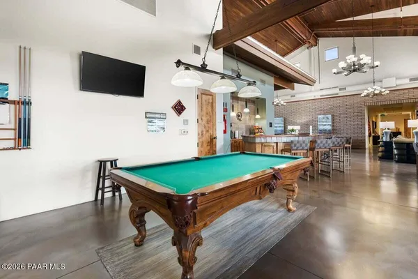 a living room with furniture a large window and a table