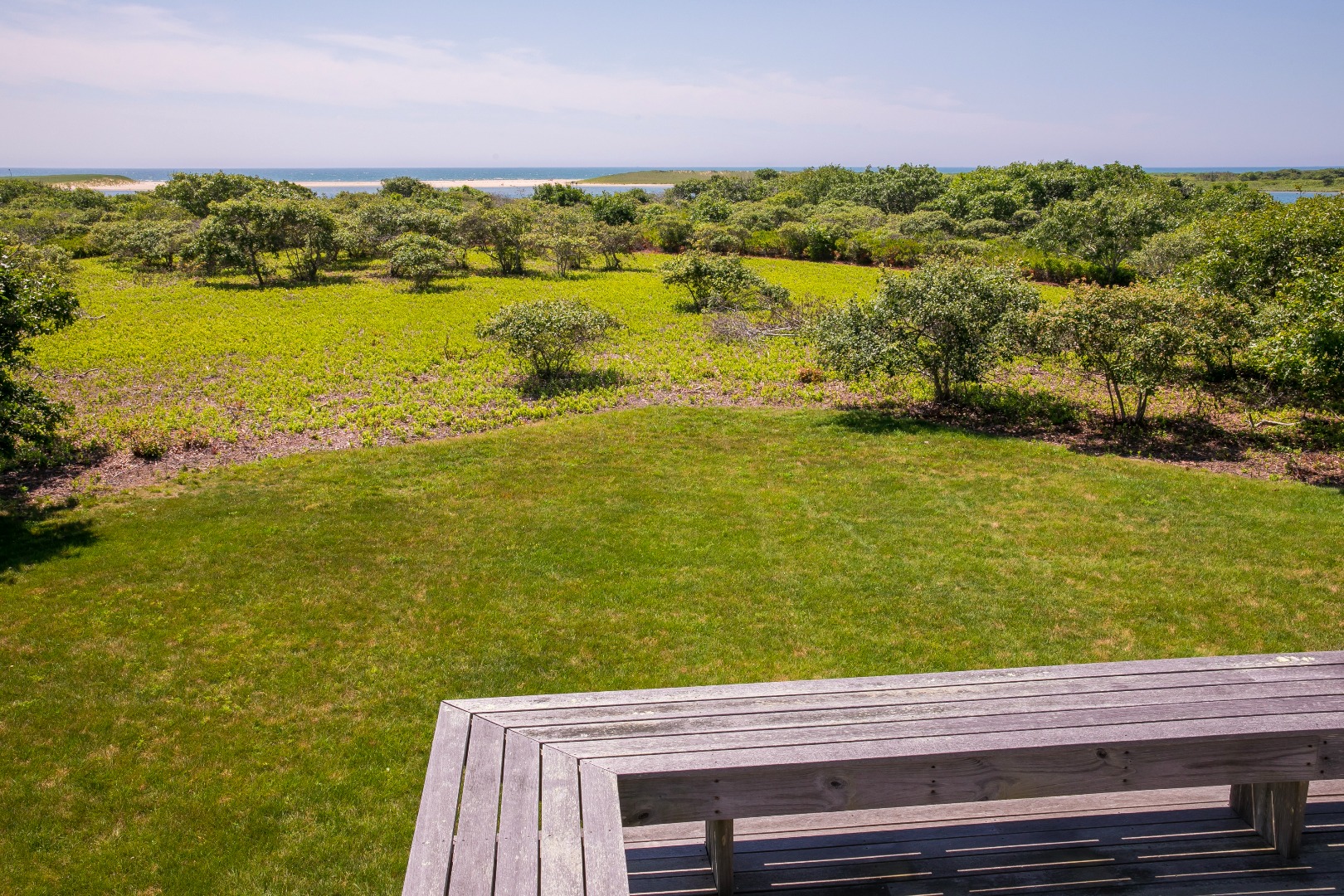 50 Oyster Watcha Road Edgartown, MA 02539 - Photo 12 of 44 a view of an ocean from a yard