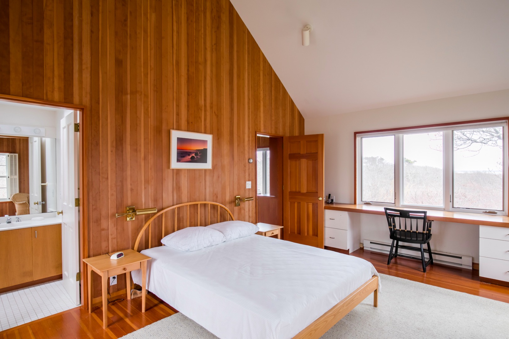 50 Oyster Watcha Road Edgartown, MA 02539 - Photo 44 of 44 a bedroom with a bed a table and chair with wooden floor