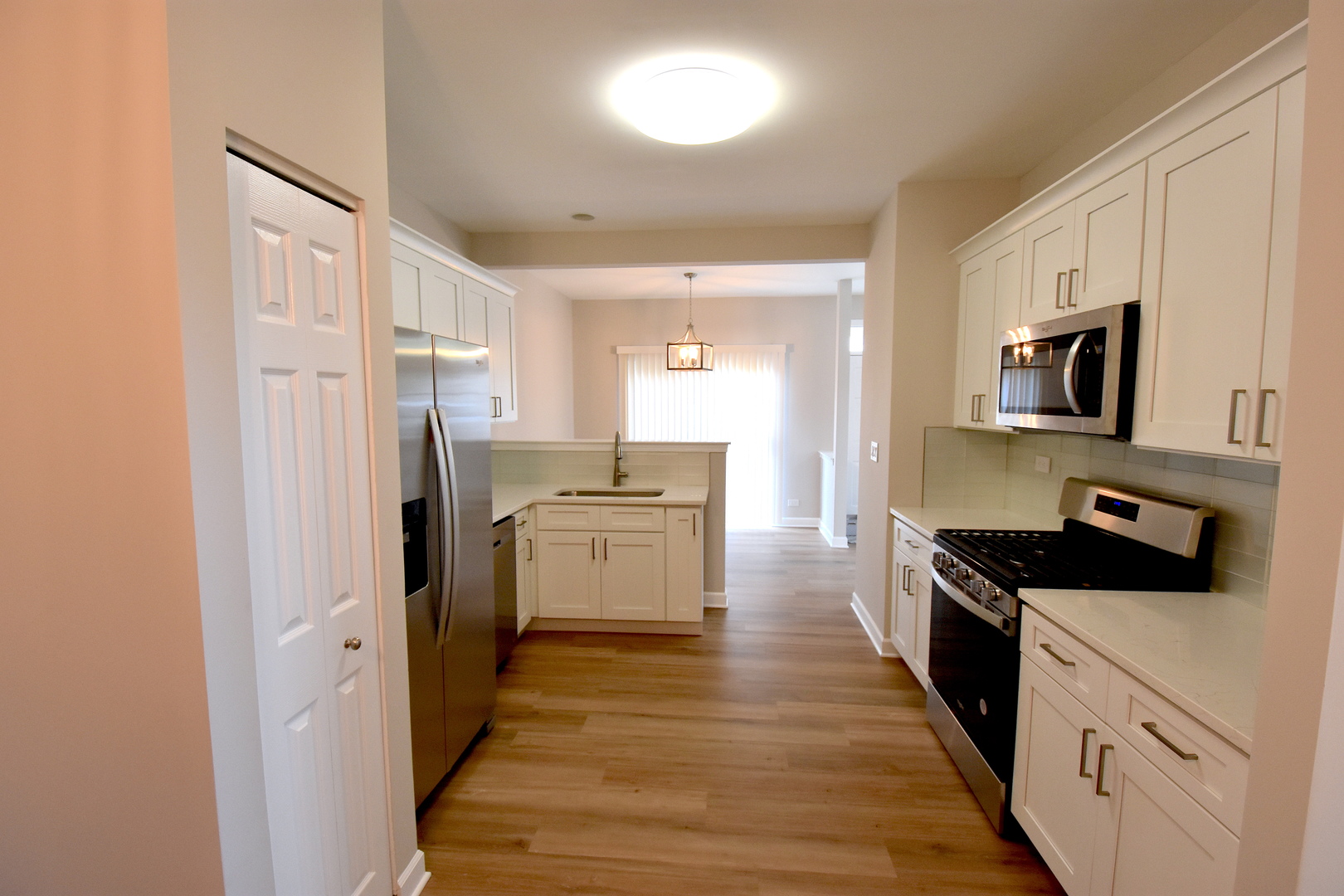 2341 Reflections Drive Aurora, IL 60502 - Photo 5 of 21 a kitchen with stainless steel appliances a refrigerator stove and sink