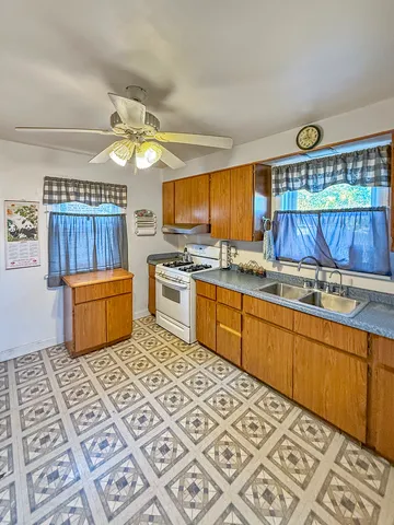 a kitchen with a stove a sink and a refrigerator