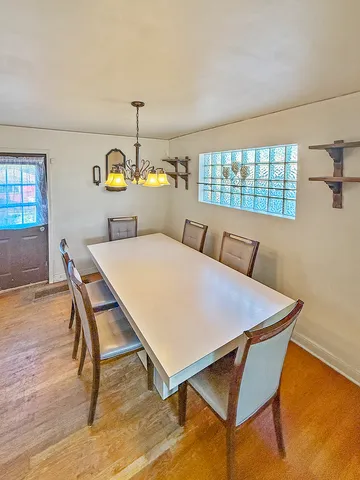 a dining room with furniture and window