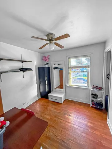 a very nice looking room with a ceiling fan and a window