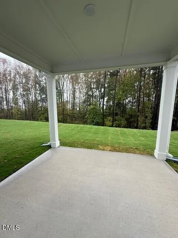 a view of a house with backyard and porch