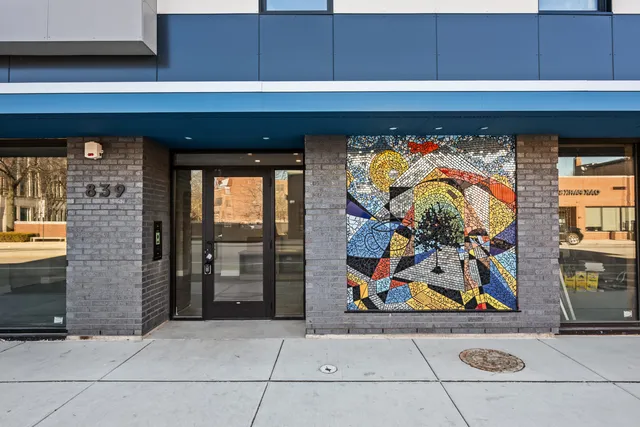 a kitchen with stainless steel appliances a refrigerator sink and wooden floor