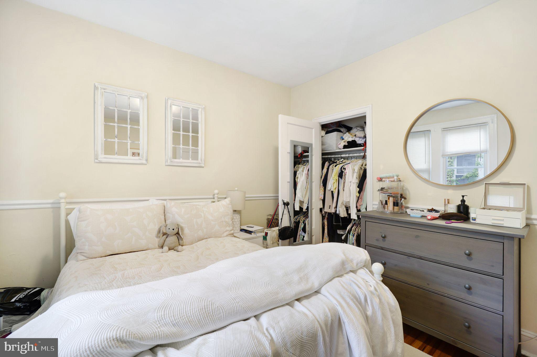 1426 12th Street Northwest, Unit 5 Washington, DC 20005 - Photo 14 of 21 a bedroom with a bed and a mirror