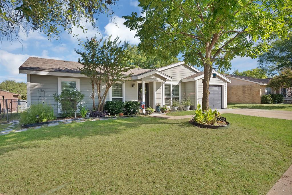 9519 County View Road Dallas, TX 75249 - Photo 3 of 31 Single-story residence featuring light gray siding, an attached garage with a dark gray door, a brown shingle roof, and a concrete driveway