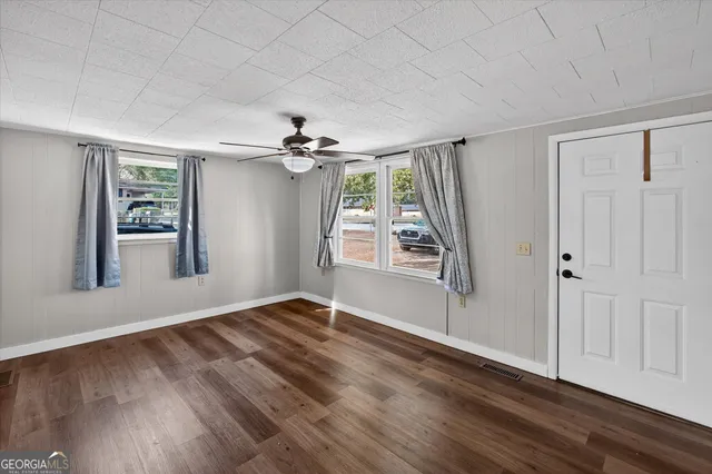 wooden floor in an empty room with a window