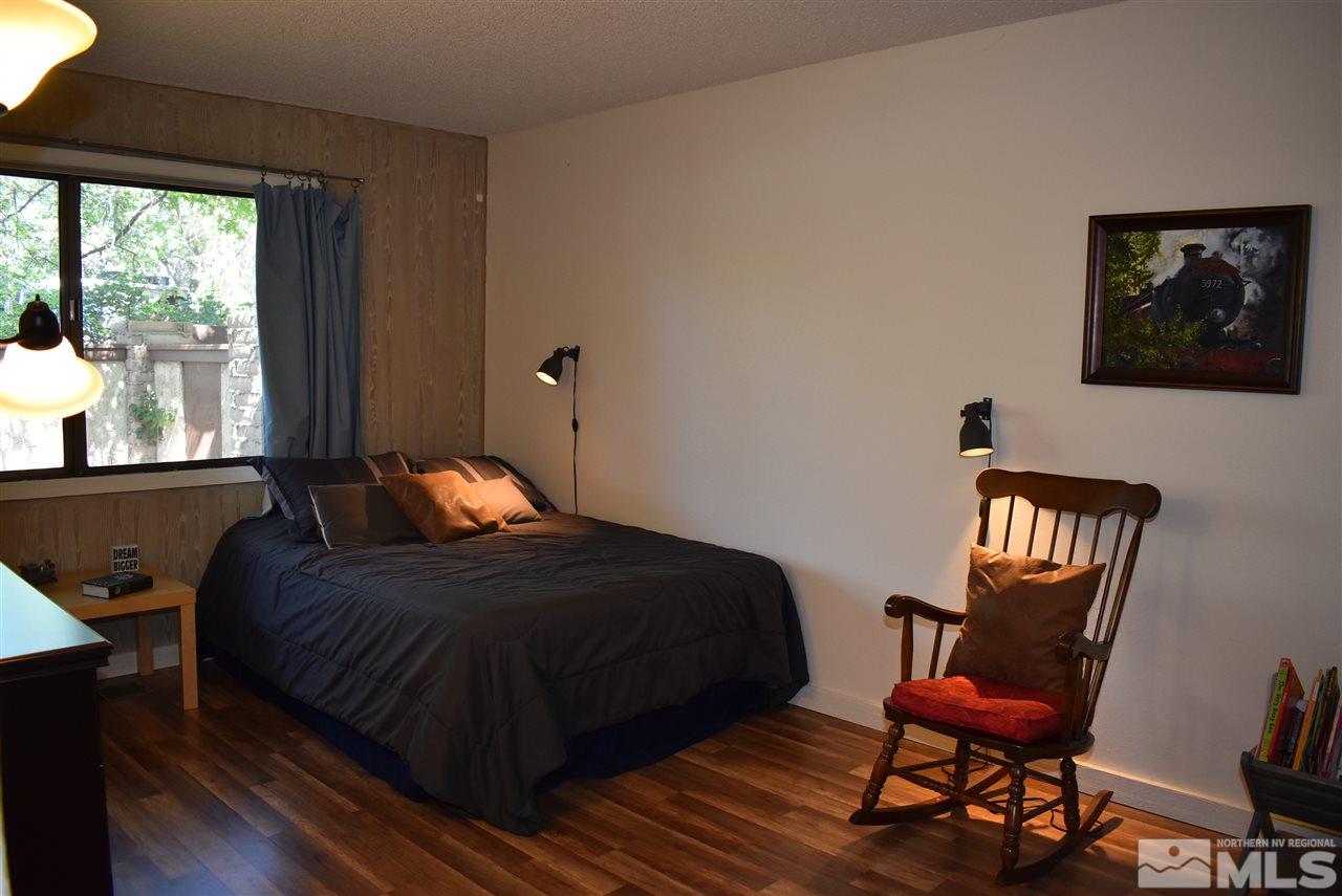1880 Sharon Way Reno, NV 89509 - Photo 15 of 25 a bedroom with a bed chair and a window