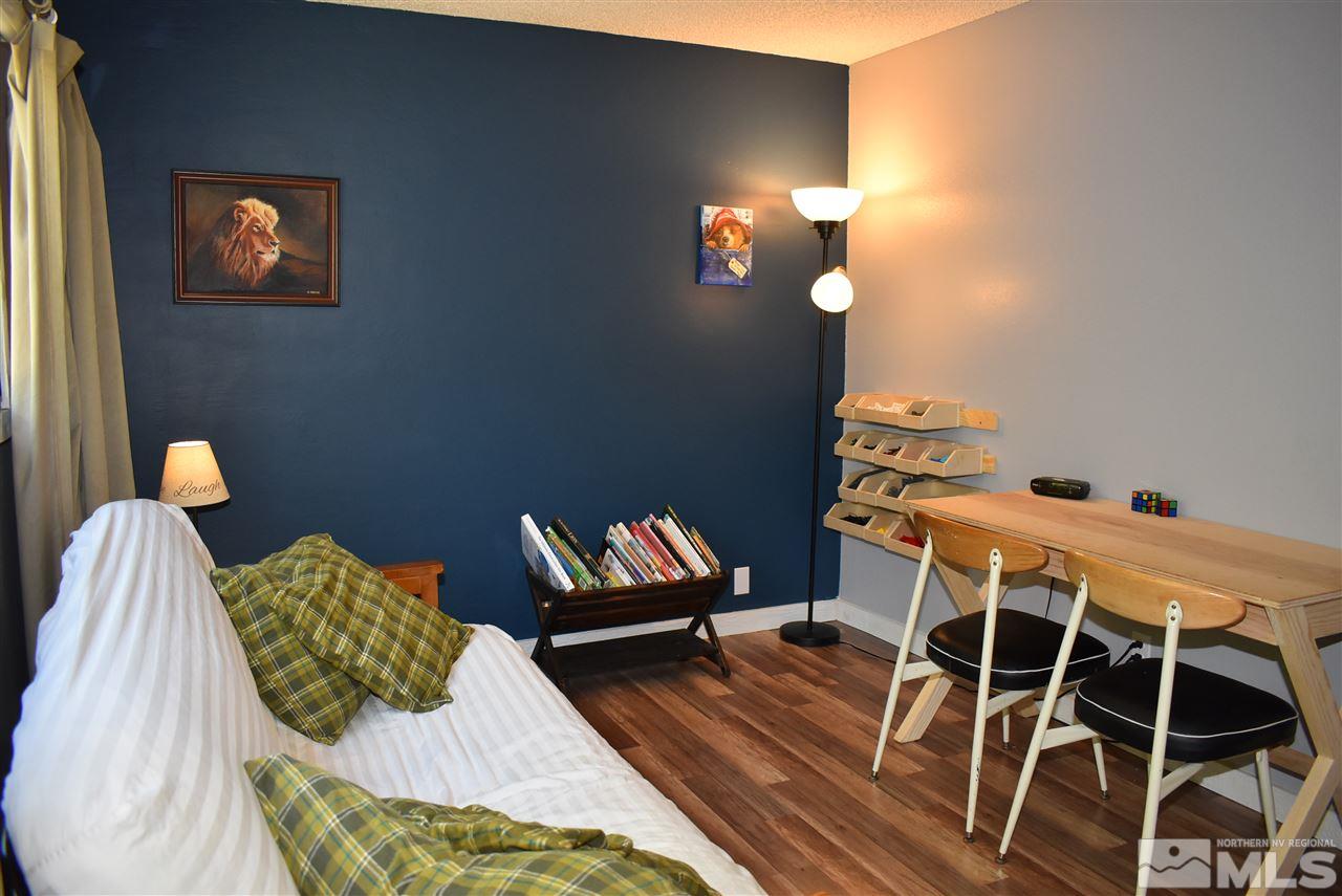 1880 Sharon Way Reno, NV 89509 - Photo 16 of 25 a bedroom with a bed and a lamp with the wooden floor