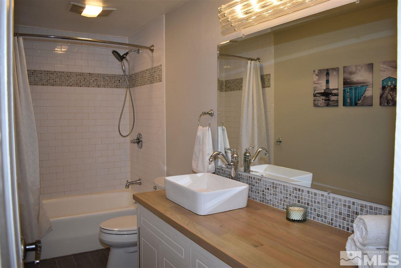 1880 Sharon Way Reno, NV 89509 - Photo 17 of 25 a bathroom with a granite countertop sink a toilet and shower