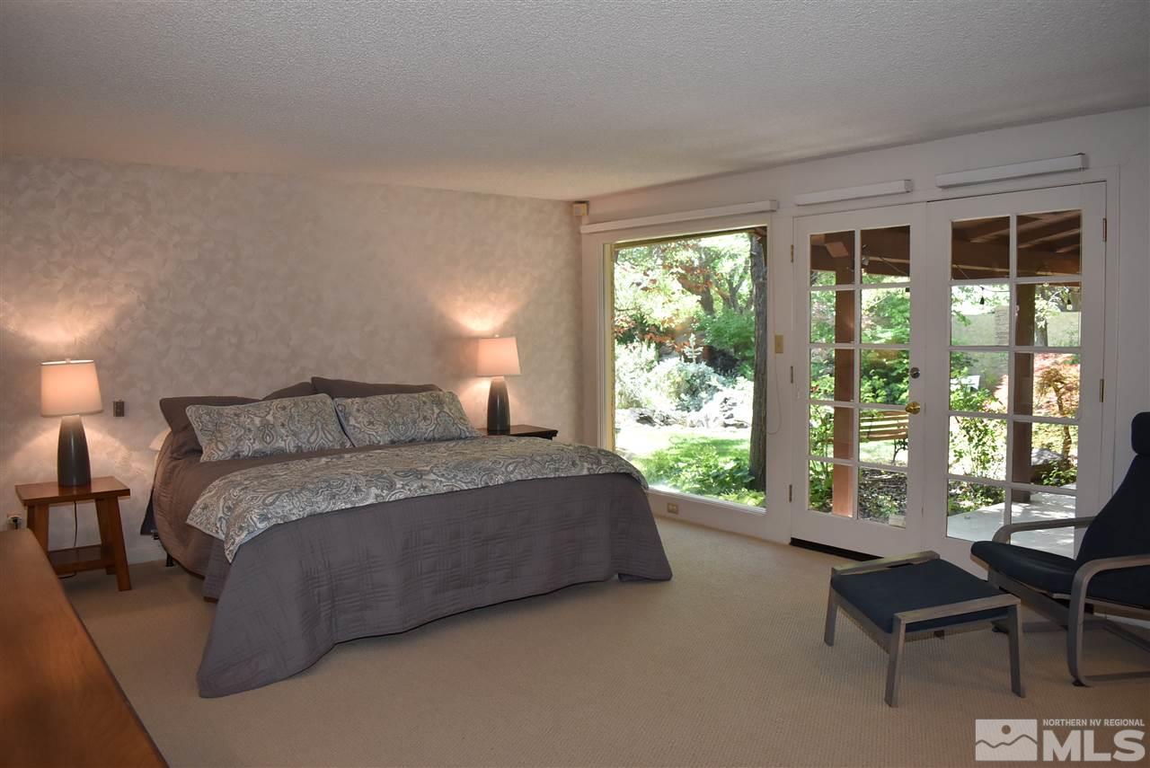 1880 Sharon Way Reno, NV 89509 - Photo 18 of 25 a spacious bedroom with a bed and a large window