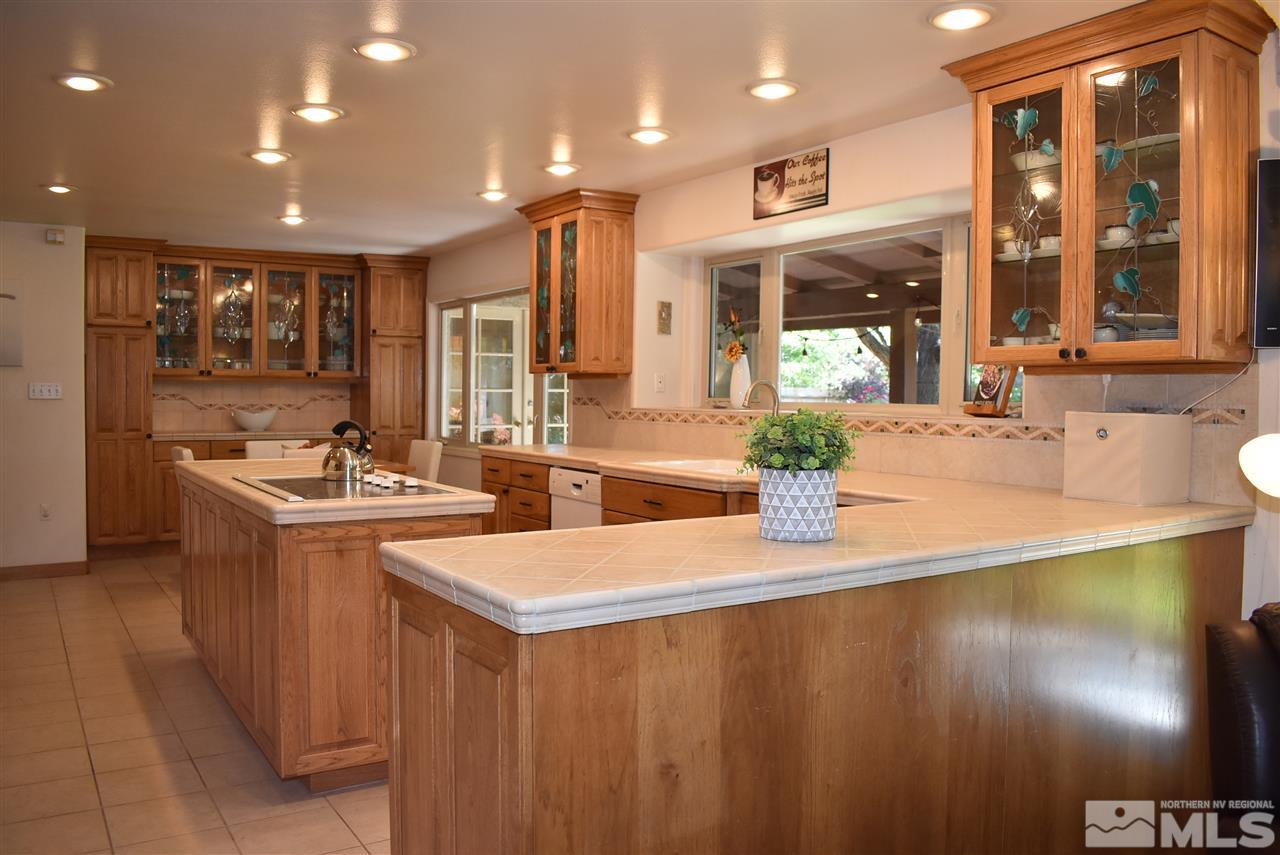 1880 Sharon Way Reno, NV 89509 - Photo 7 of 25 a kitchen with stainless steel appliances granite countertop a sink a stove and a refrigerator