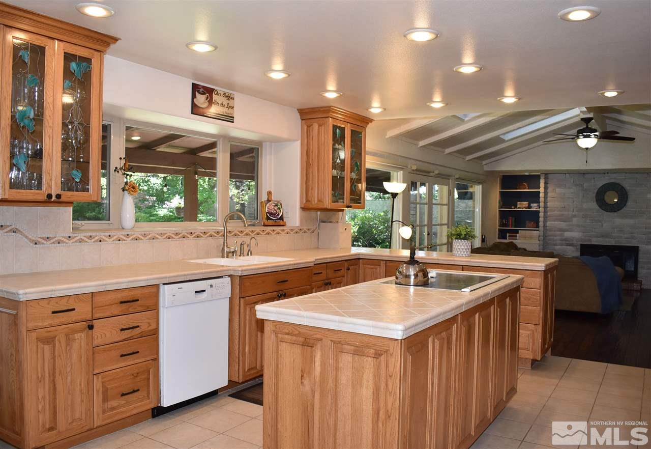 1880 Sharon Way Reno, NV 89509 - Photo 8 of 25 a kitchen with stainless steel appliances granite countertop a sink and a refrigerator
