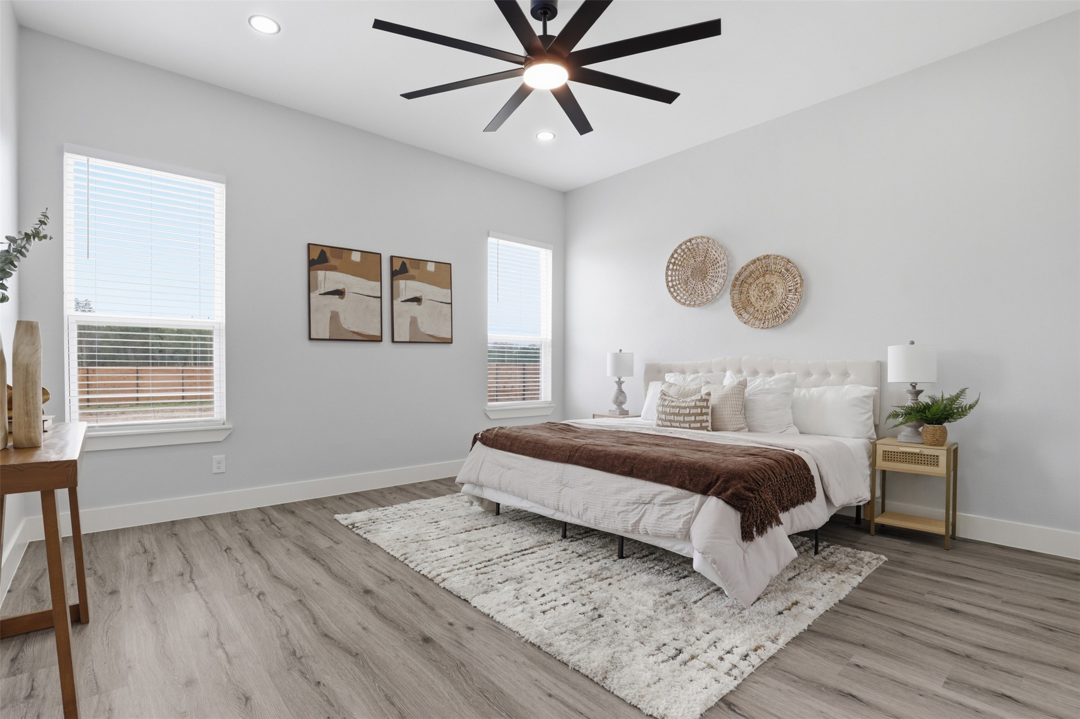 113 Los Robles Road Elgin, TX 78621 - Photo 7 of 20 Spacious bedroom featuring light gray walls and wood-finish flooring