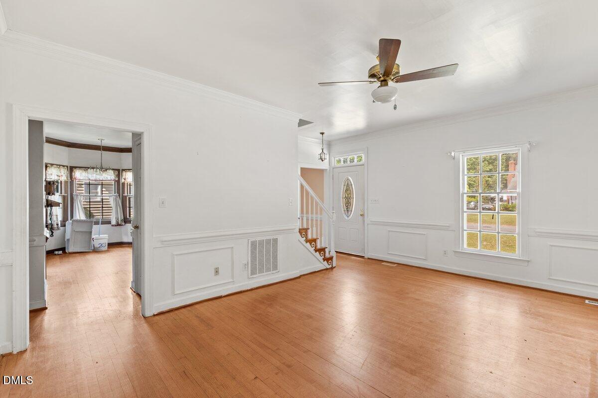 3812 Providence Road Rocky Mount, NC 27803 - Photo 4 of 18 an empty room with wooden floor and windows