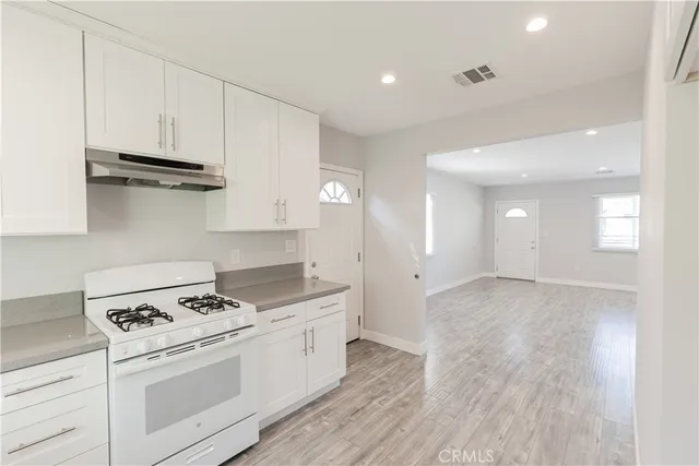 a kitchen with a stove and a sink