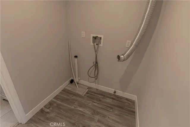 a room with a wooden floor and white wall