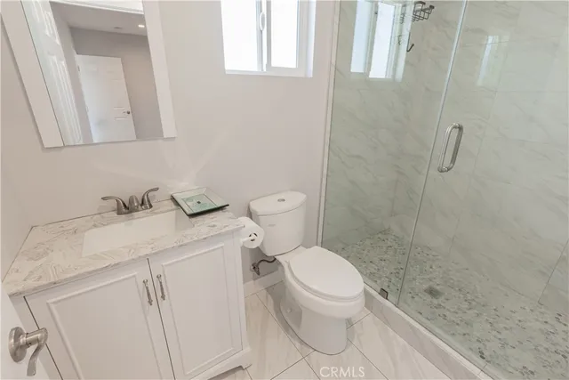 a white toilet sitting next to a bathroom sink
