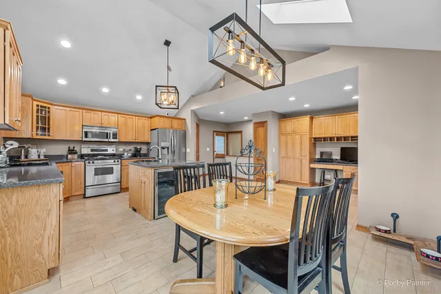 a kitchen with stainless steel appliances granite countertop a sink a stove and a refrigerator