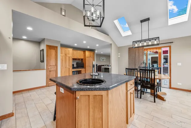 a kitchen with stainless steel appliances a refrigerator and a stove top oven