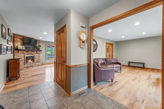 a living room with granite countertop furniture and a wooden floor