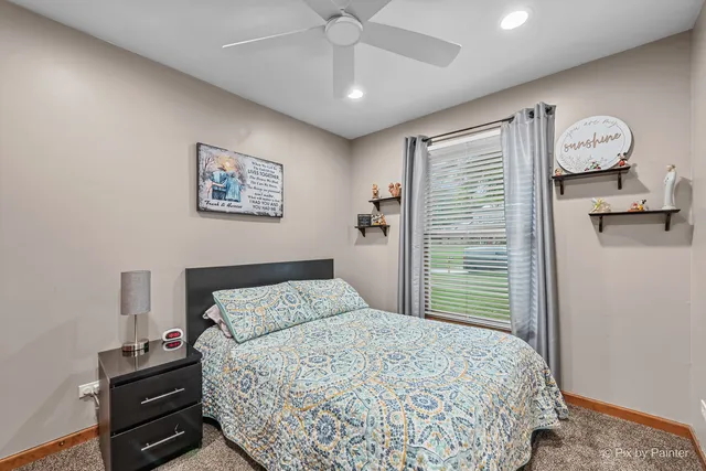 a bathroom with a sink a toilet a mirror and shower