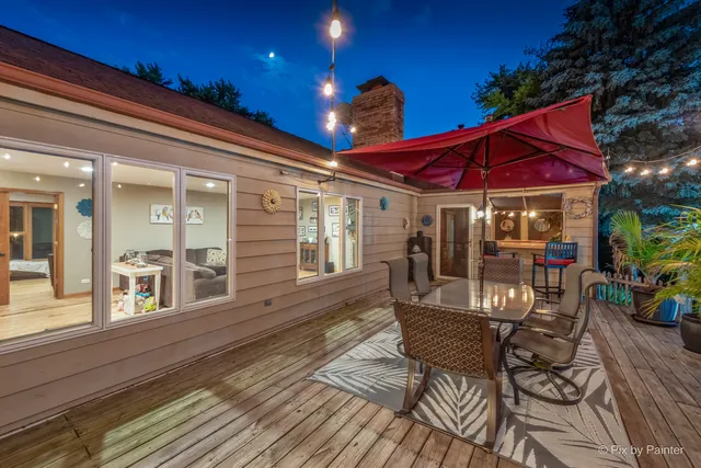 a view of a patio with table and chairs under an umbrella