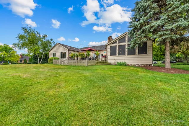 a front view of a house with a big yard