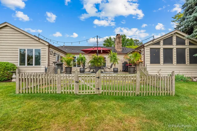 a front view of a house with a garden and deck