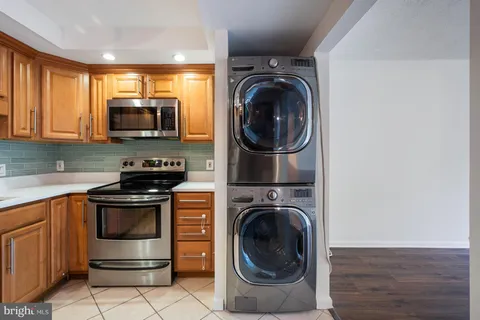 a kitchen with a refrigerator a sink and cabinets