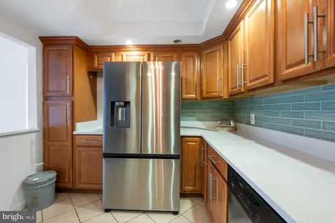 an empty room with wooden floor chandelier fan and windows