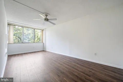 a bathroom with a granite countertop sink toilet mirror and bathtub
