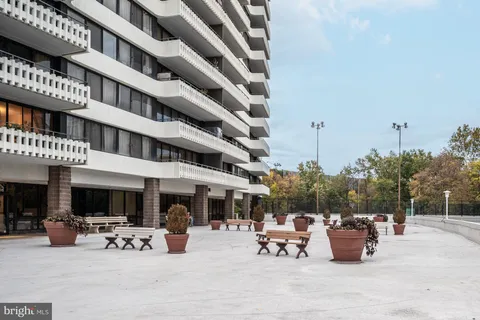 a view of a patio with dining table and chairs and potted plants