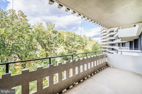 a large kitchen with stainless steel appliances kitchen island granite countertop a large stove a sink dishwasher and a dining table with the view of kitchen