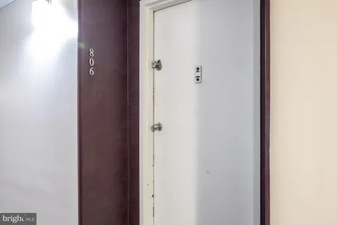 a view of a hallway with wooden floor and closet