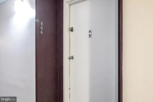 a view of a hallway with wooden floor and closet