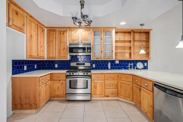 a kitchen with stainless steel appliances granite countertop a stove and a refrigerator
