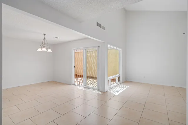 an empty room with a empty space and windows