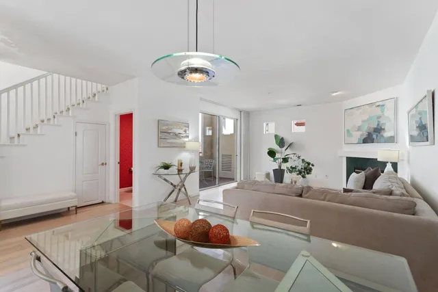 a living room with furniture kitchen and a chandelier