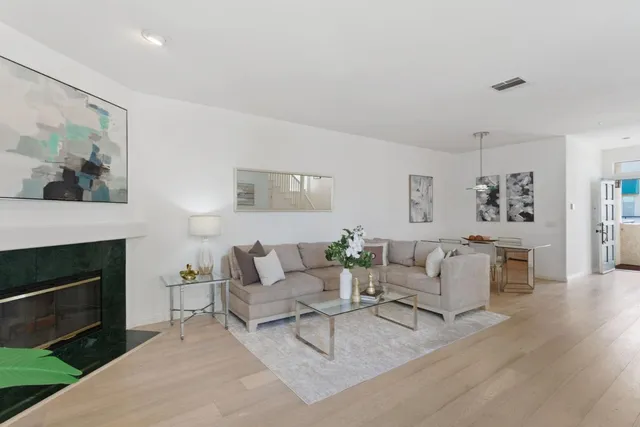 a living room with furniture a fireplace and a painting on the wall
