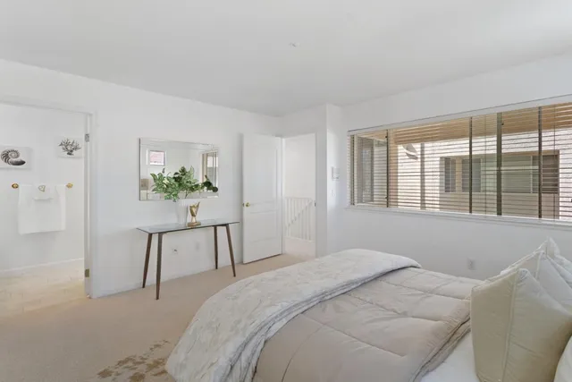 a bedroom with a bed and a chair