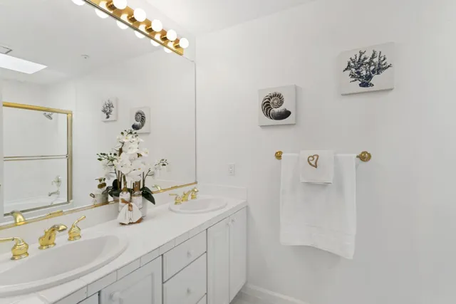 a bathroom with a sink a mirror and a shower